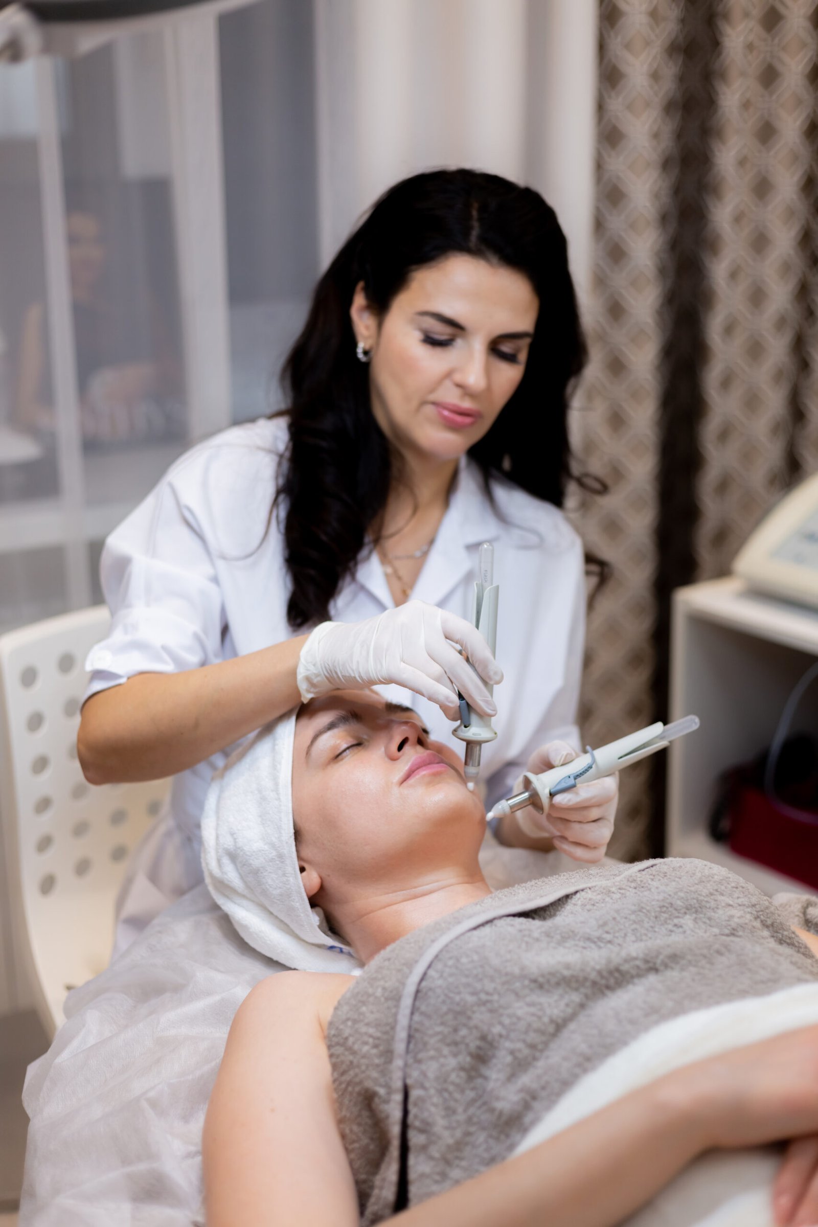young beautiful girl lies beautician s table receives procedures scaled